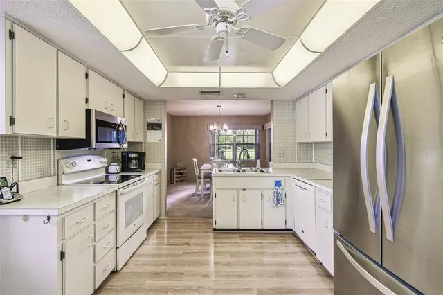 a kitchen with stainless steel appliances a stove microwave and cabinets