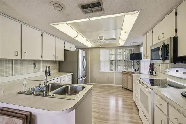 a dining room with furniture a chandelier and window