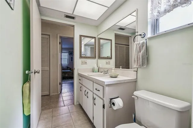 a view of a bedroom with a bed and a window