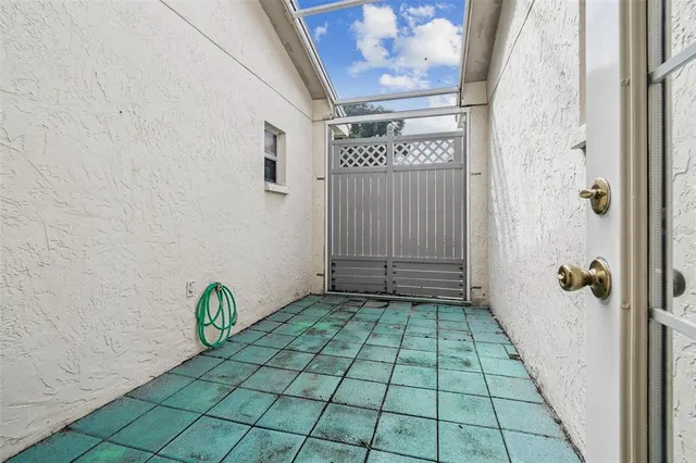 a living room with furniture and a large window with garden view
