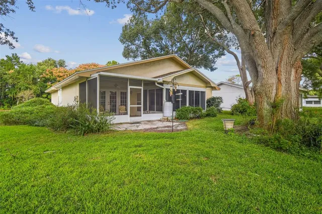 an aerial view of residential houses with outdoor space and lake view