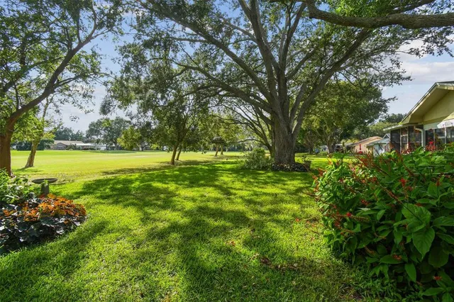 a aerial view of house with yard and green space