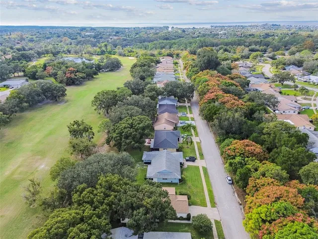 an aerial view of a house with garden space and street view