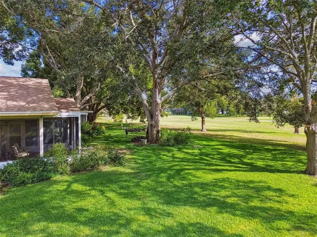 an aerial view of a house with outdoor space pool seating area and fire pit