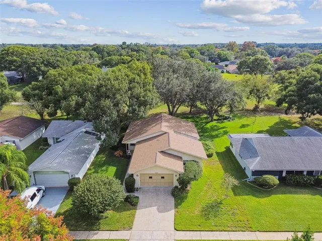 an aerial view of a house with a yard