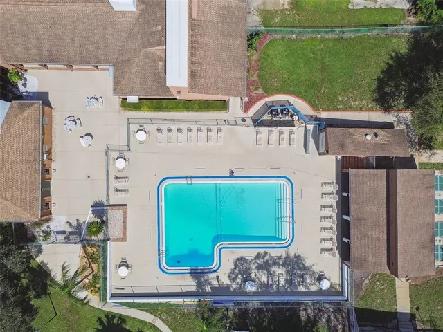 an aerial view of residential houses with outdoor space and street view