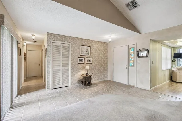 a view of a livingroom with wooden floor and windows