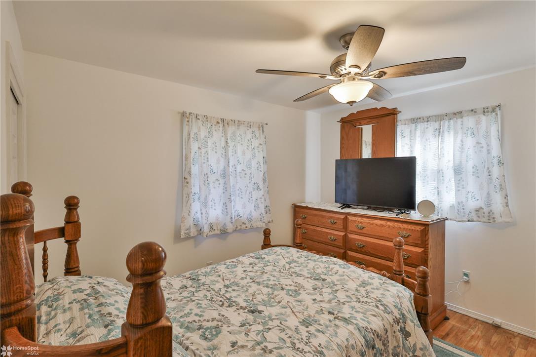 205 West Moorestown Road Wind Gap, PA 18091 - Photo 11 of 20 A comforting bedroom space featuring durable hardwood flooring and efficient cooling from a ceiling fan.
