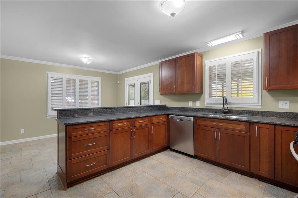 127 Windsor Drive Calhoun, GA 30701 - Photo 17 of 57 a kitchen with a sink and wooden cabinets