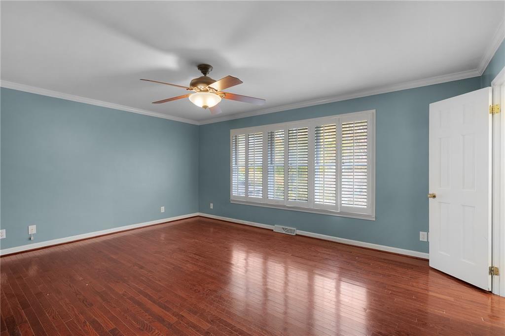 127 Windsor Drive Calhoun, GA 30701 - Photo 20 of 57 a view of empty room with wooden floor and fan