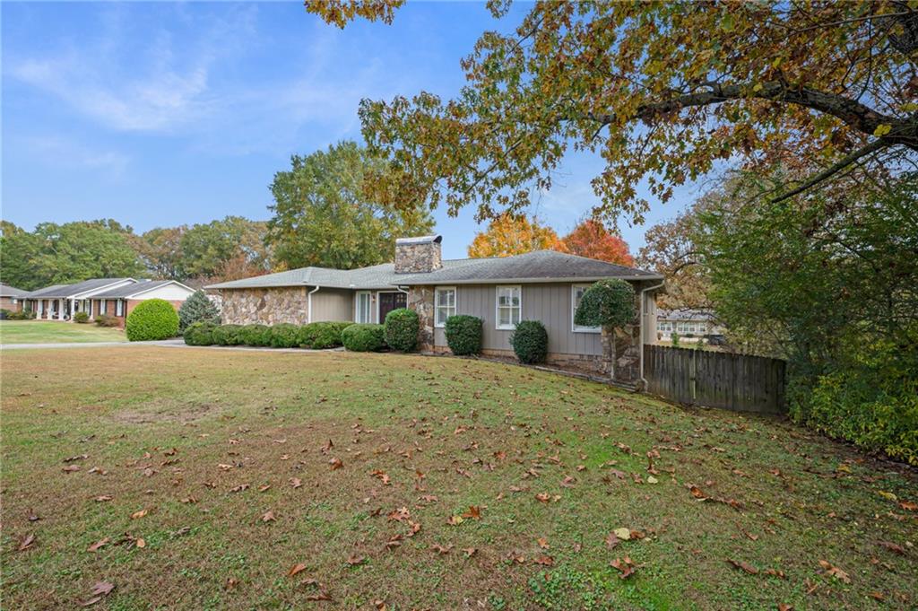 127 Windsor Drive Calhoun, GA 30701 - Photo 2 of 57 a front view of a house with a garden