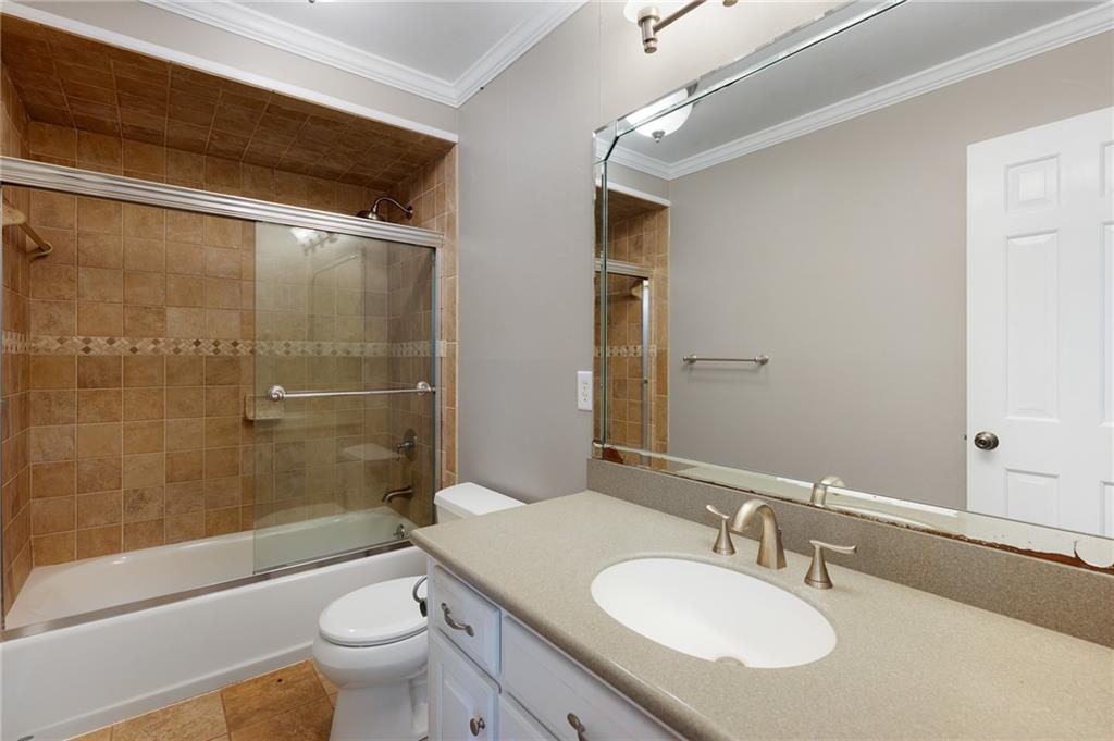 127 Windsor Drive Calhoun, GA 30701 - Photo 22 of 57 a bathroom with a granite countertop sink toilet and shower