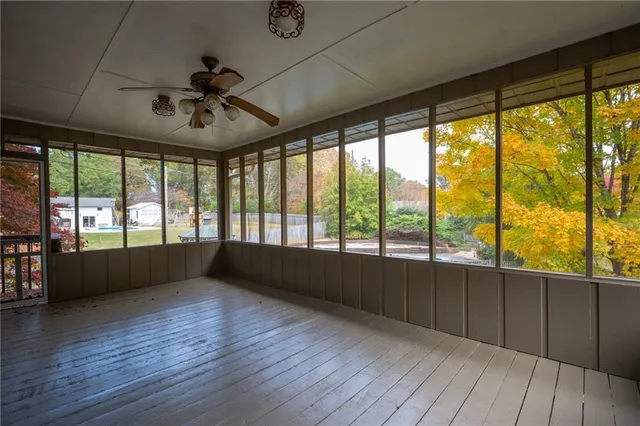a view of hallway with furniture and a large window