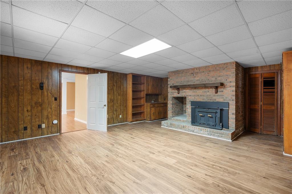 127 Windsor Drive Calhoun, GA 30701 - Photo 38 of 57 an empty room with wooden floor fireplace and windows