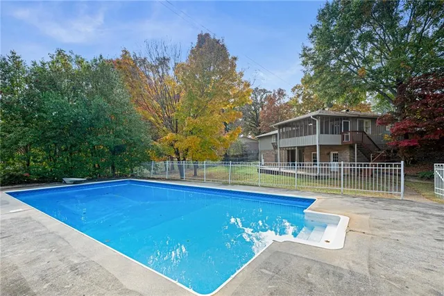 a view of a house with a yard balcony and tree s