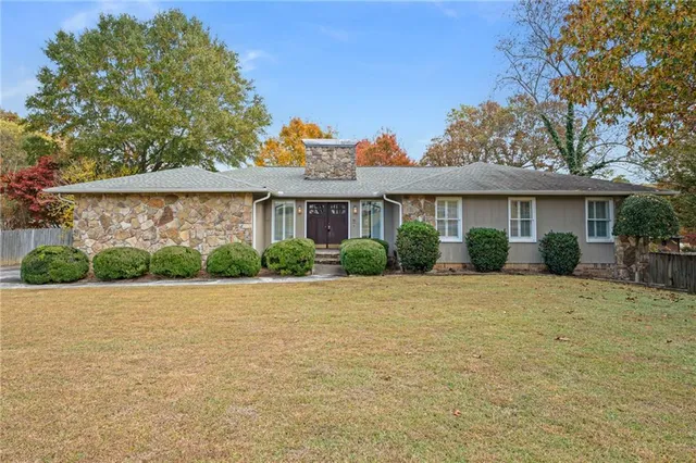 a front view of a house with a garden