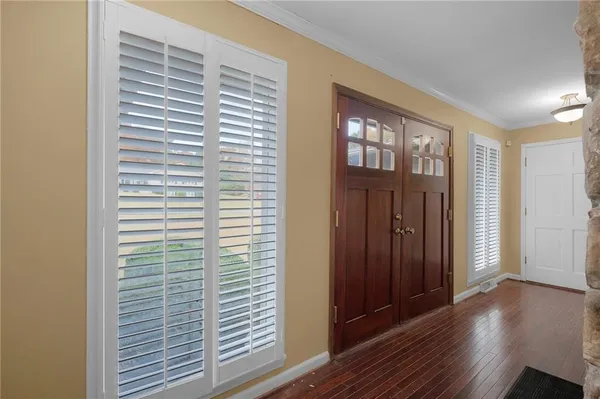 a view of empty room with wooden floor and fireplace