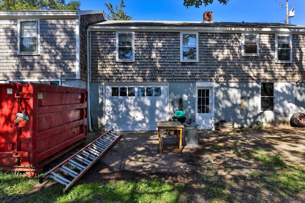 5 Indian Neck Road Wellfleet, MA 02667 - Photo 8 of 24 a view of a patio with table and chairs and potted plants