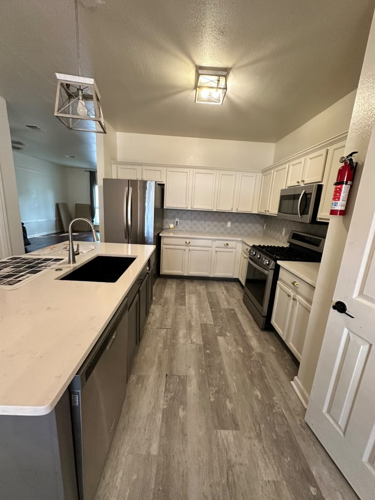 1981 Prairie Rock Way Round Rock, TX 78664 - Photo 6 of 22 An inviting kitchen features a generous breakfast bar island and clean stone-look countertops.