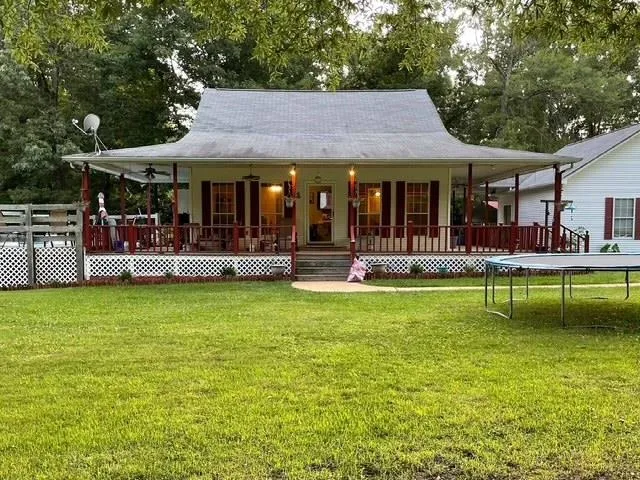 a front view of a house with a yard table and chairs