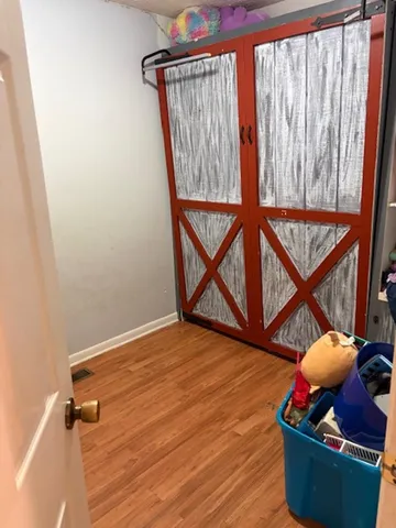 a room with wooden floor and shoes