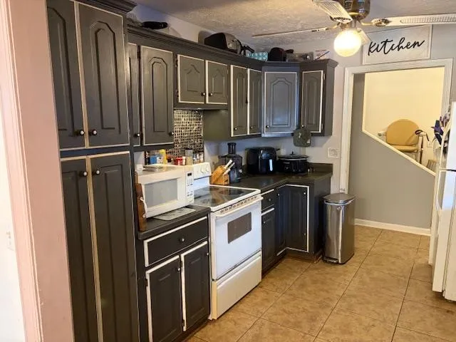 a kitchen with a sink stove and refrigerator
