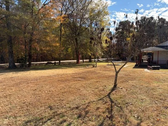 a view of a yard with basketball court