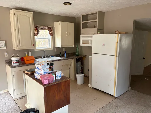 a utility room with cabinets washer and dryer