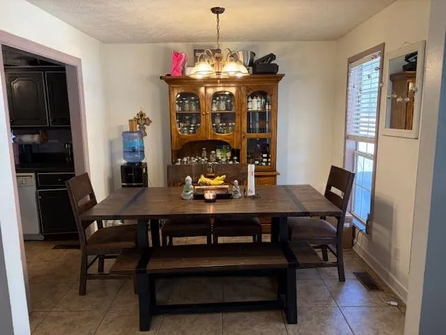 a view of a dining room with furniture and chandelier