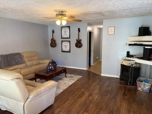 a living room with furniture and wooden floor