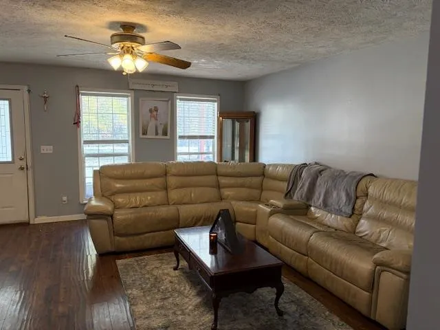 a living room with furniture and a chandelier