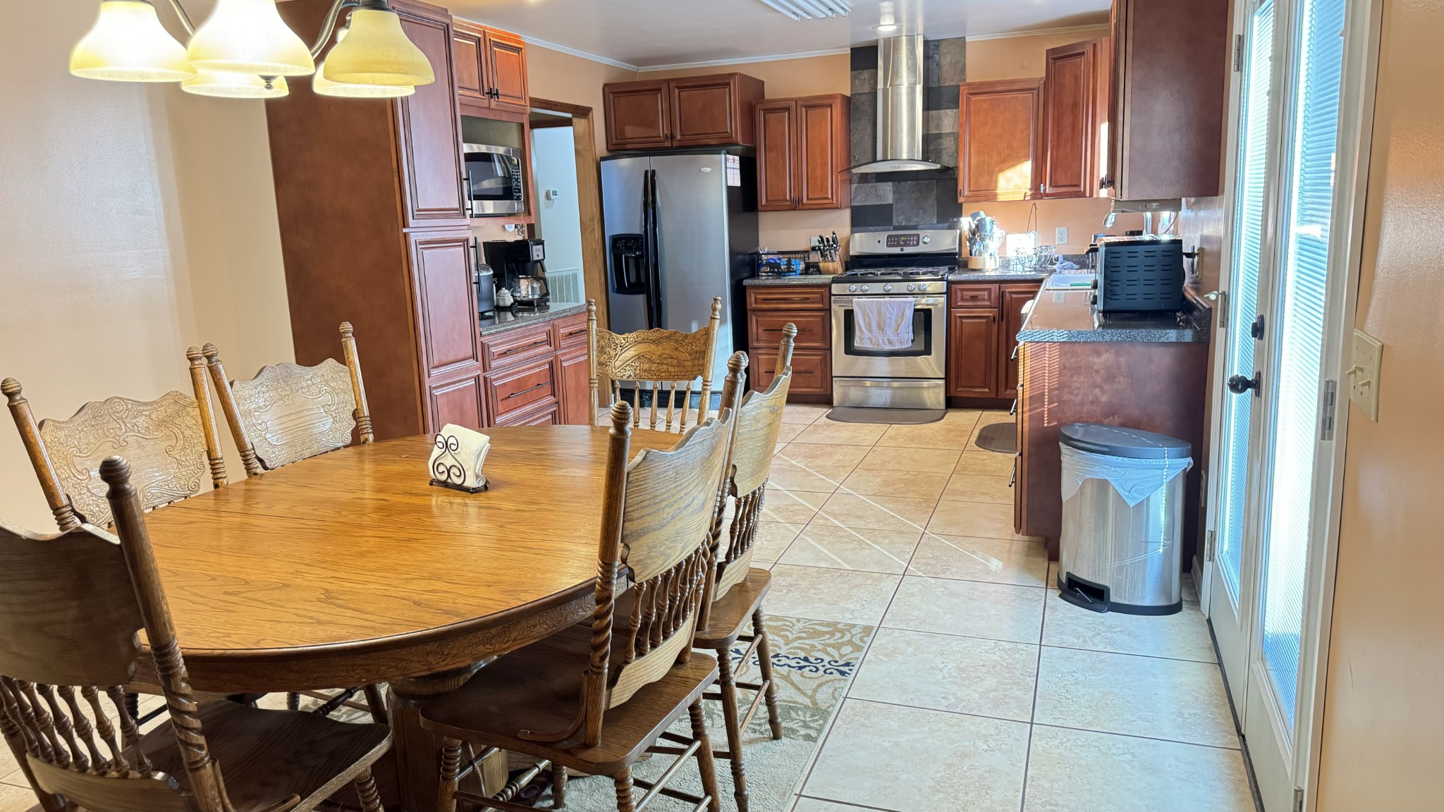 510 Brandon Road Manchester, TN 37355 - Photo 28 of 50 a kitchen with stainless steel appliances kitchen island granite countertop a table chairs and a refrigerator