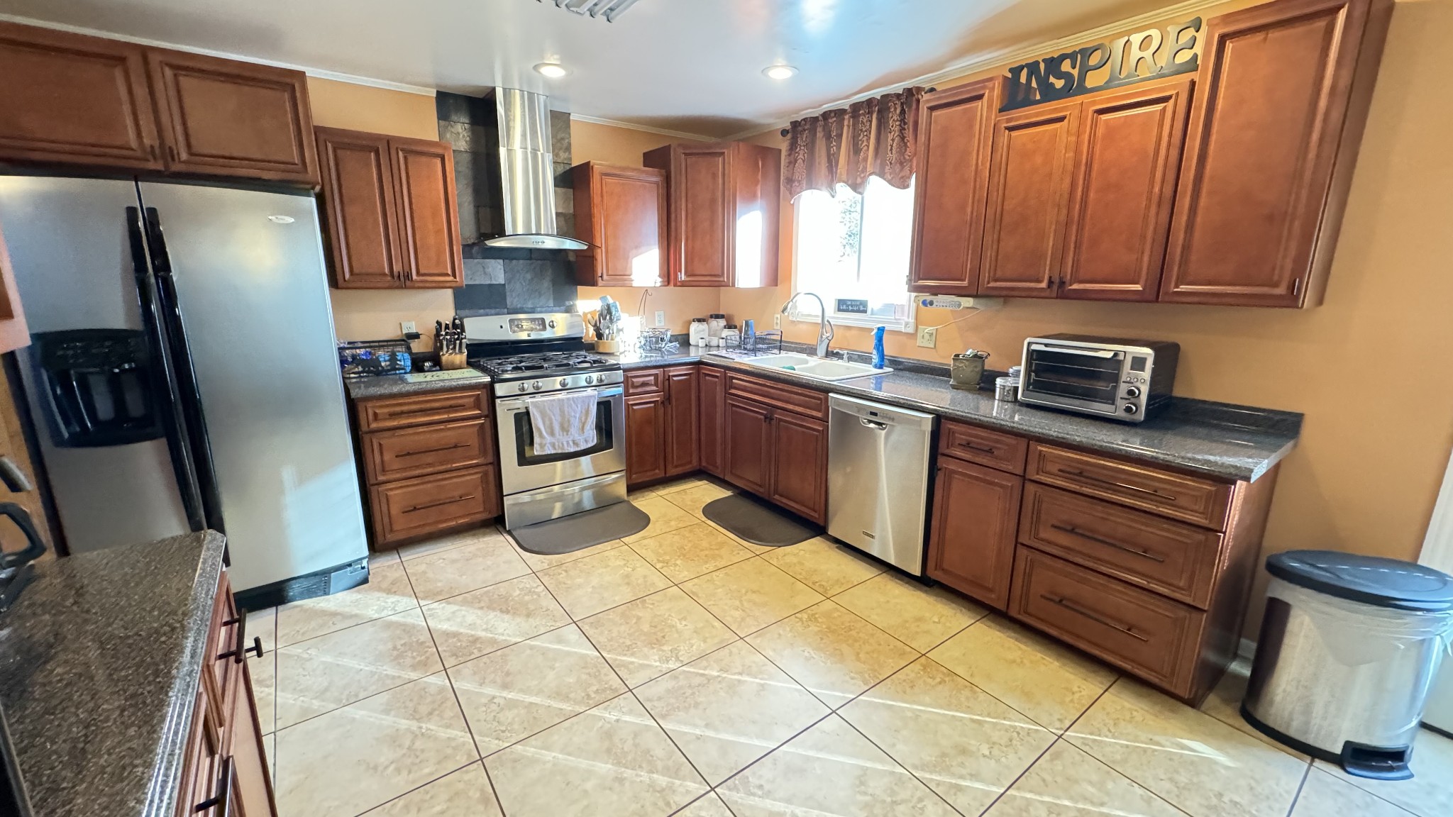 510 Brandon Road Manchester, TN 37355 - Photo 30 of 50 a kitchen with stainless steel appliances granite countertop a stove a sink dishwasher and a refrigerator