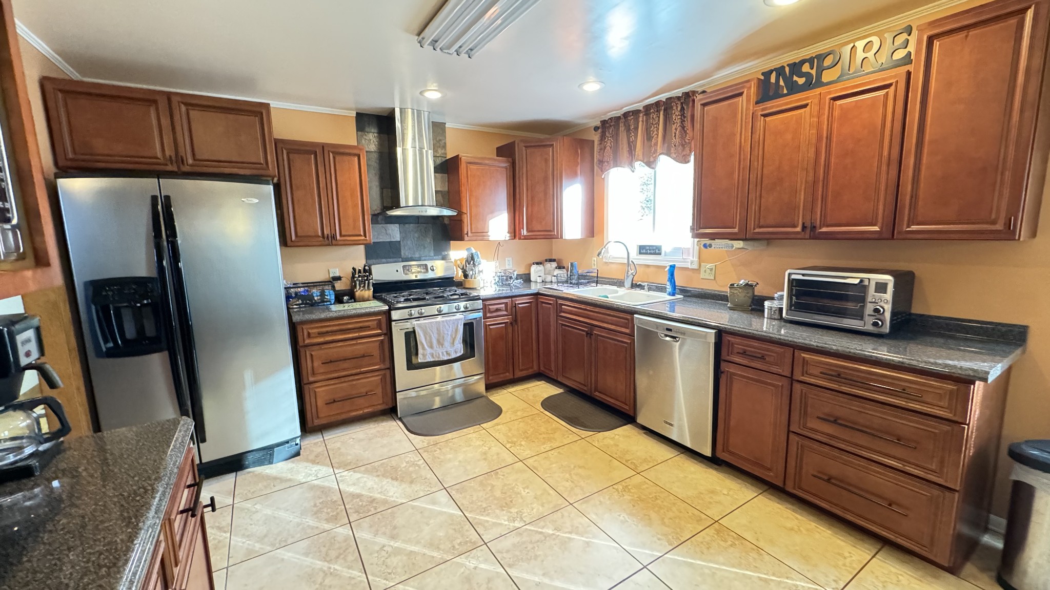 510 Brandon Road Manchester, TN 37355 - Photo 31 of 50 a kitchen with stainless steel appliances granite countertop a sink stove refrigerator and cabinets