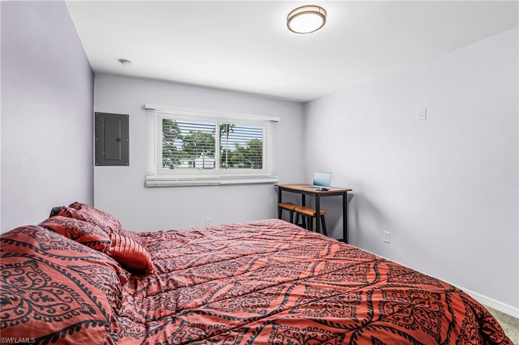 34 Hamlin Court Lehigh Acres, FL 33936 - Photo 15 of 29 a bedroom with a bed and a window