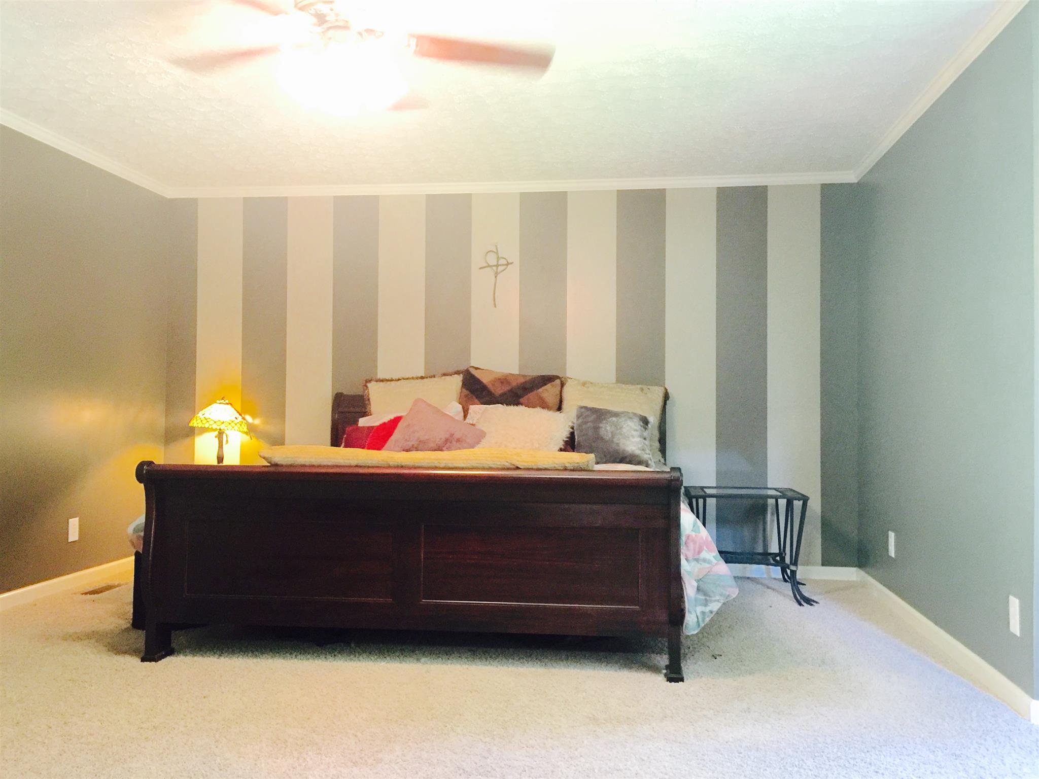 6762 New Chapel Road Springfield, TN 37172 - Photo 13 of 30 a bed sitting in a bedroom next to a window