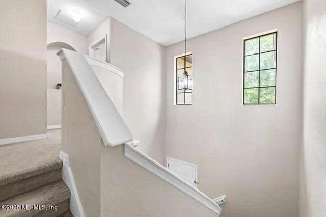 a bedroom with a large bed and a flat tv screen on dresser
