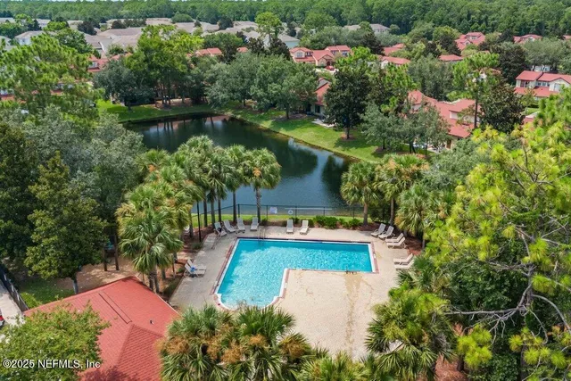 an aerial view of house with yard swimming pool and outdoor seating