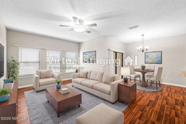 a living room with furniture and wooden floor