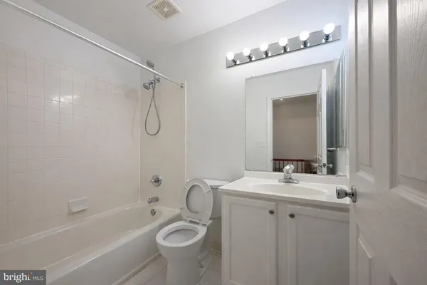 a bathroom with a sink vanity tub and shower