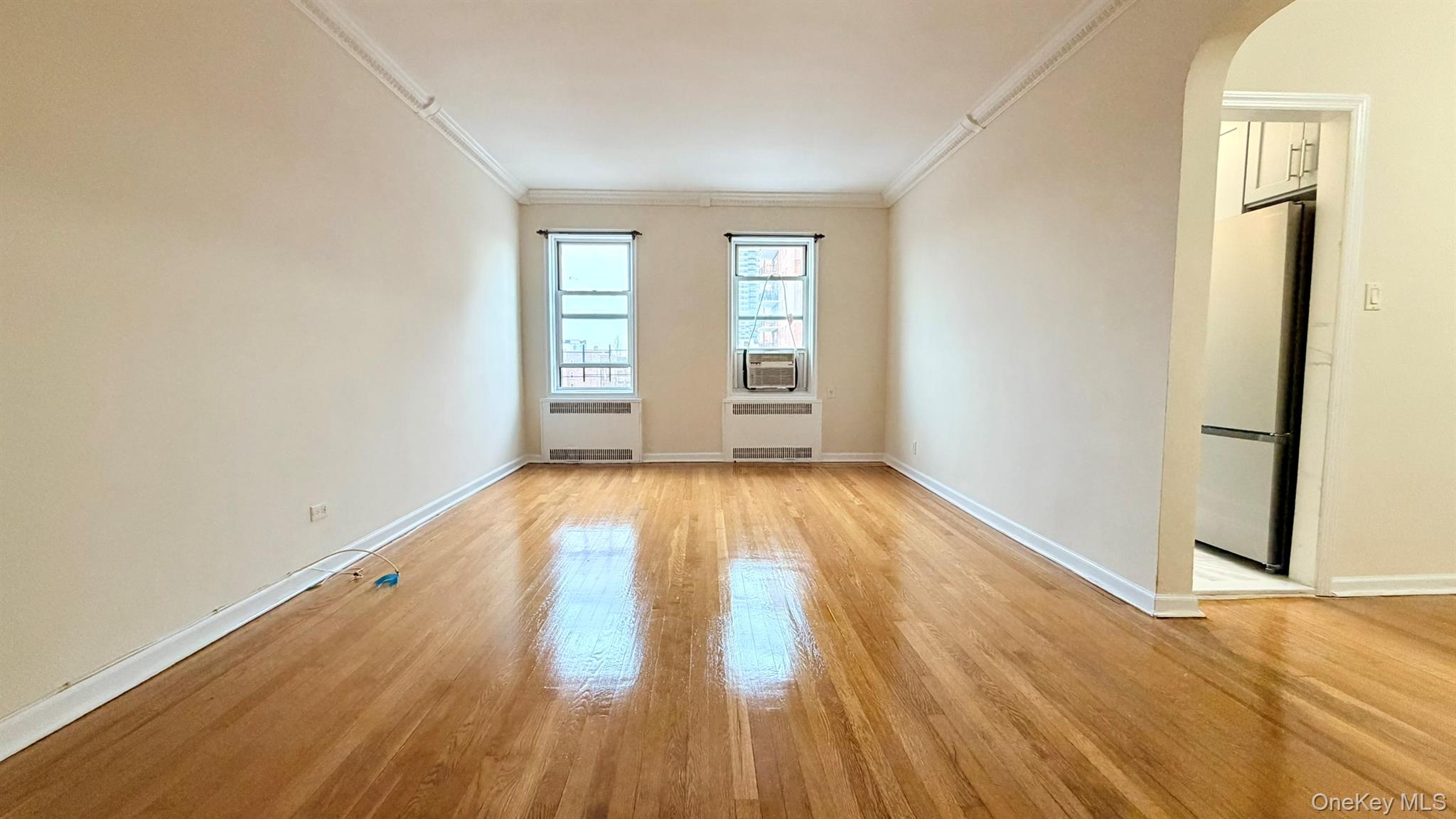 112-15 72nd Road, Unit 602 Queens, NY 11375 - Photo 1 of 12 wooden floor in an empty room with a window