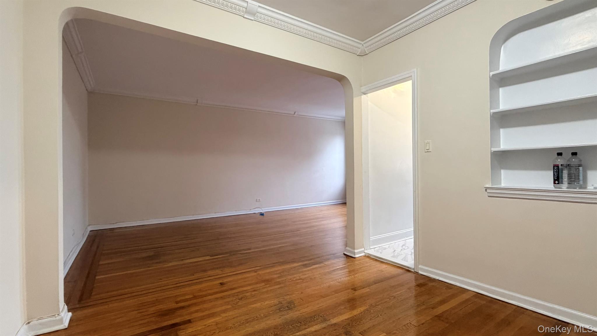 112-15 72nd Road, Unit 602 Queens, NY 11375 - Photo 2 of 12 a view of an empty room with wooden floor and a window
