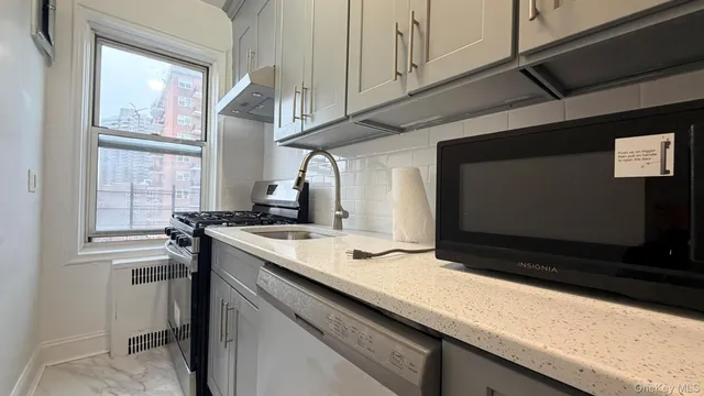 a kitchen with a sink and a stove