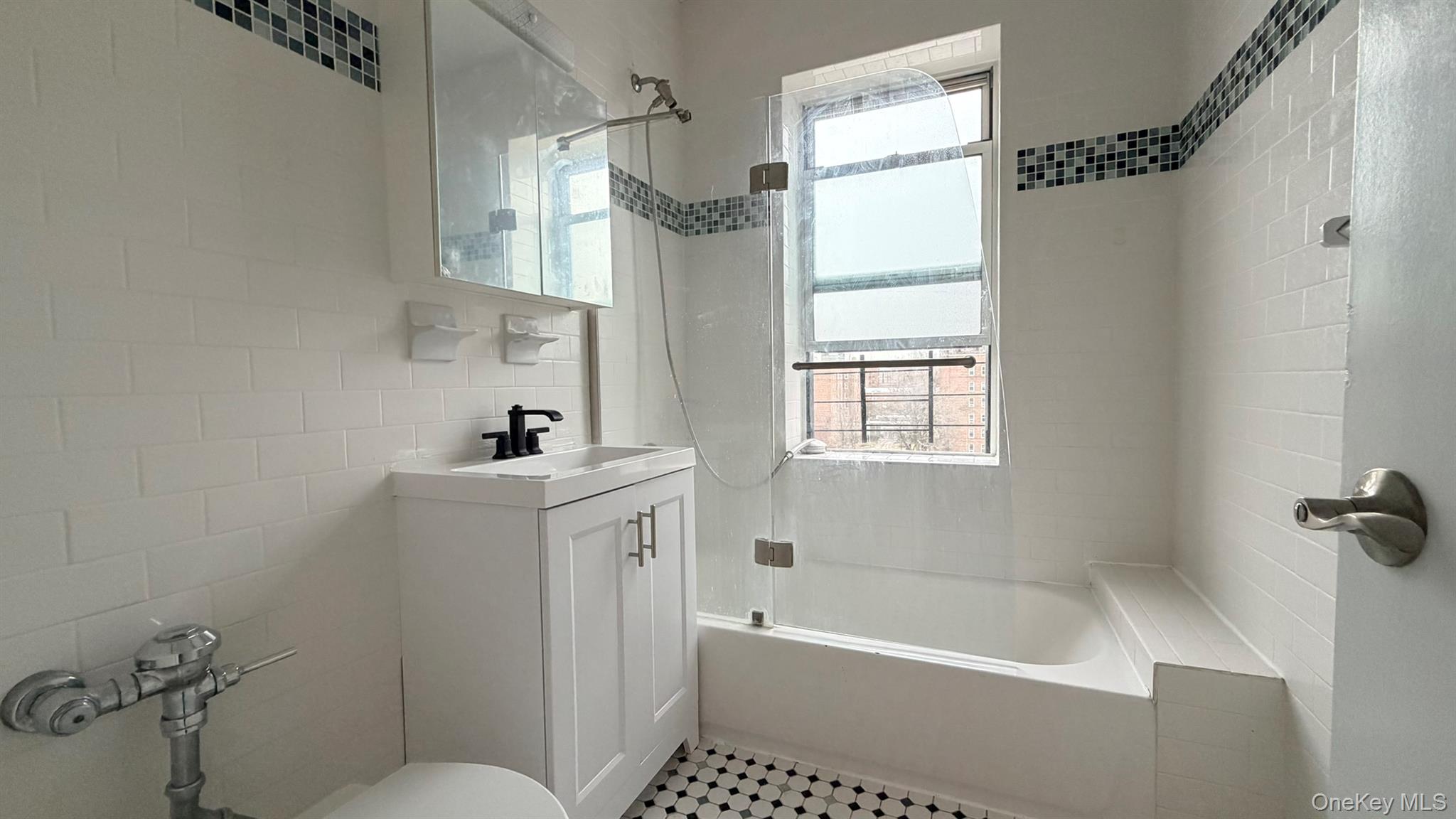 112-15 72nd Road, Unit 602 Queens, NY 11375 - Photo 8 of 12 a bathroom with a sink a toilet and a bathtub
