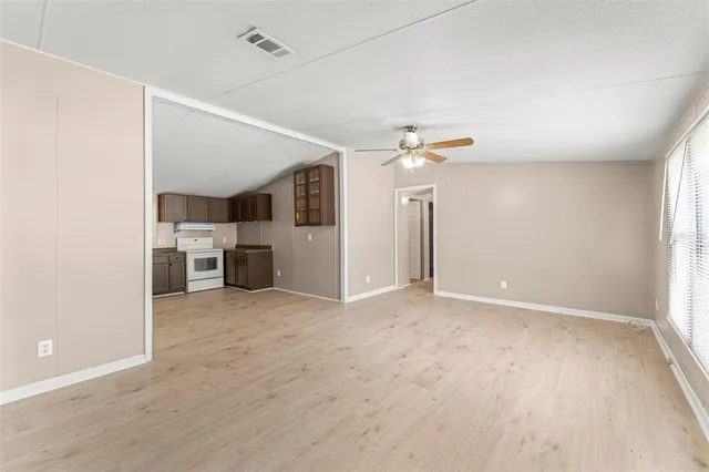 an empty room with a kitchen and a sink