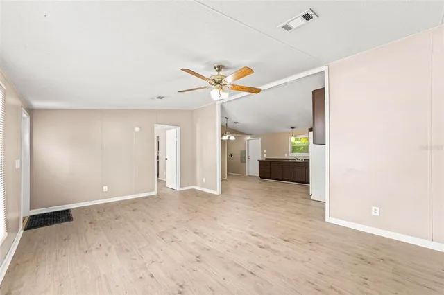 a view of a room with wooden floor and white walls