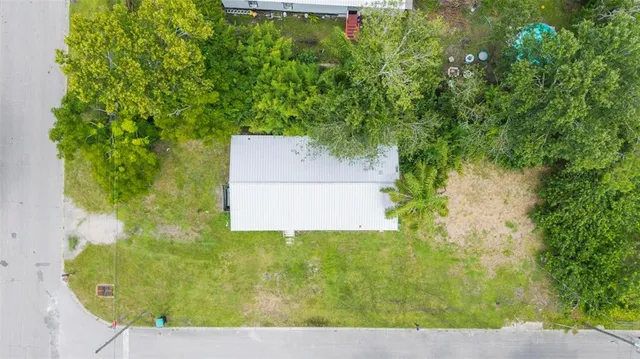 a front view of a house with yard and green space
