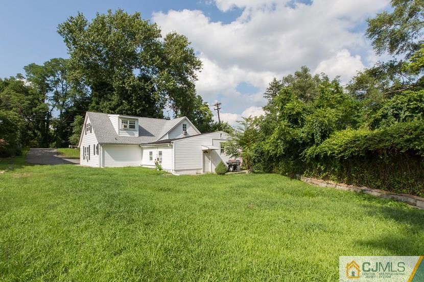 613 Old Post Road Edison, NJ 08817 - Photo 11 of 20 a view of a house with a big yard potted plants and large tree