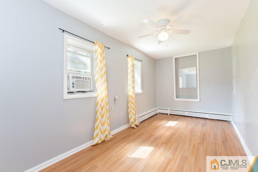 613 Old Post Road Edison, NJ 08817 - Photo 14 of 20 an empty room with wooden floor and windows