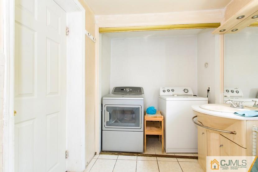 613 Old Post Road Edison, NJ 08817 - Photo 18 of 20 a utility room with cabinets washer and dryer